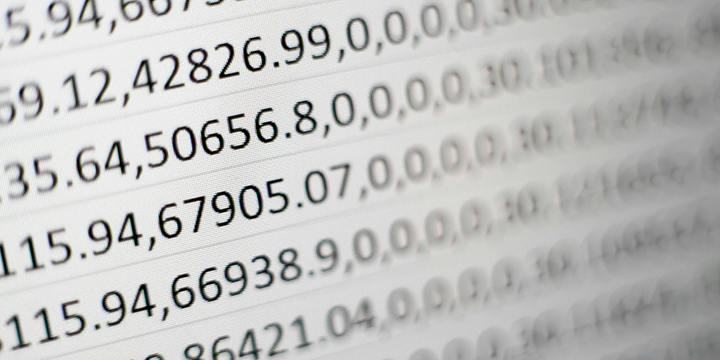 Close-up of rows of comma-separated decimal figures on a white page, fading out of focus